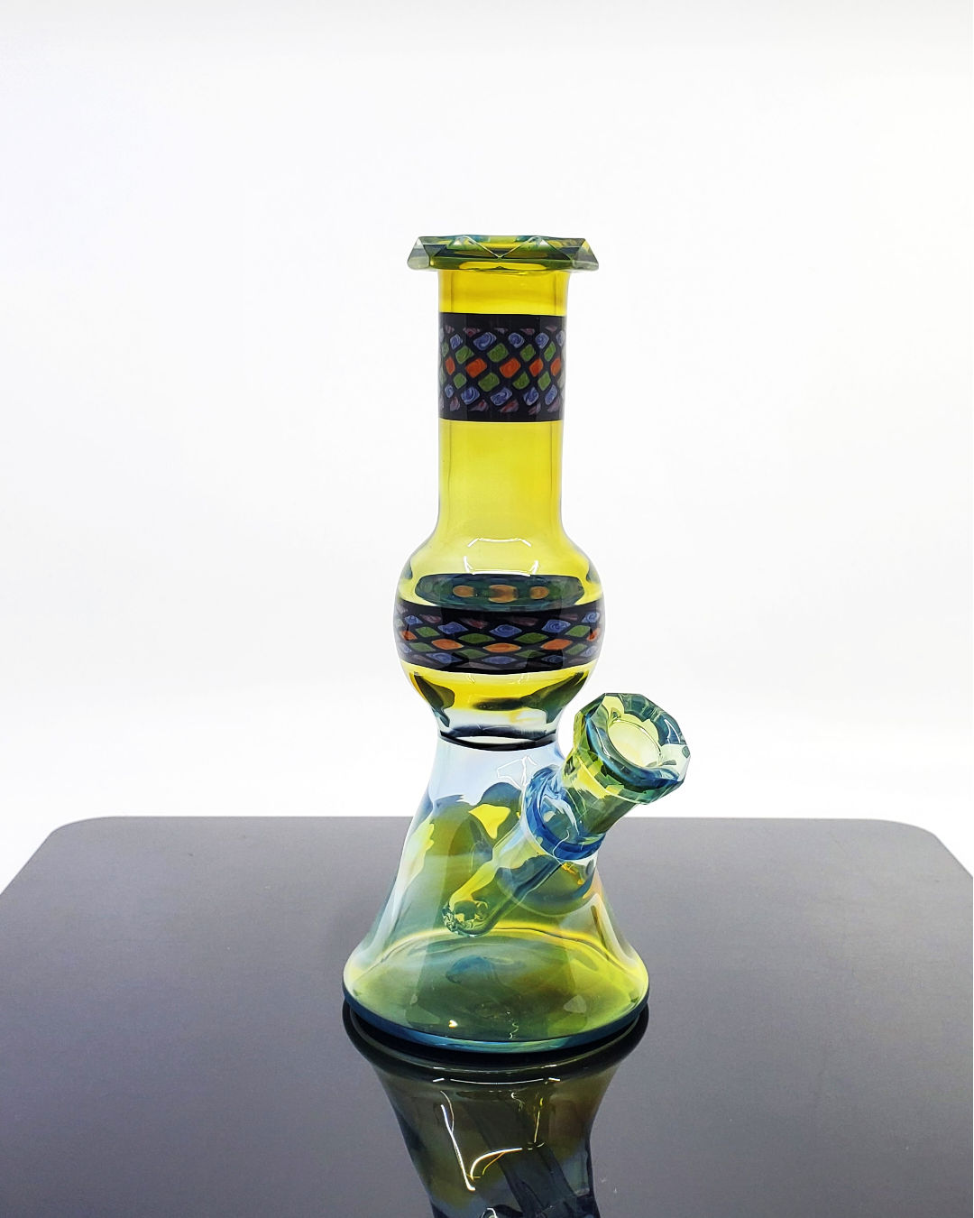 10mm Faceted Jammer Handcrafted Rig: The Shipley Glass Plantphibian Jammer is an artisan-crafted rig with a unique faceted design and sleek lines, providing smooth functionality and a modern aesthetic for any glass enthusiast.