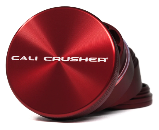 Cali Crusher 2.5" 4 Piece Grinder held in hand, demonstrating its compact size and premium build quality.