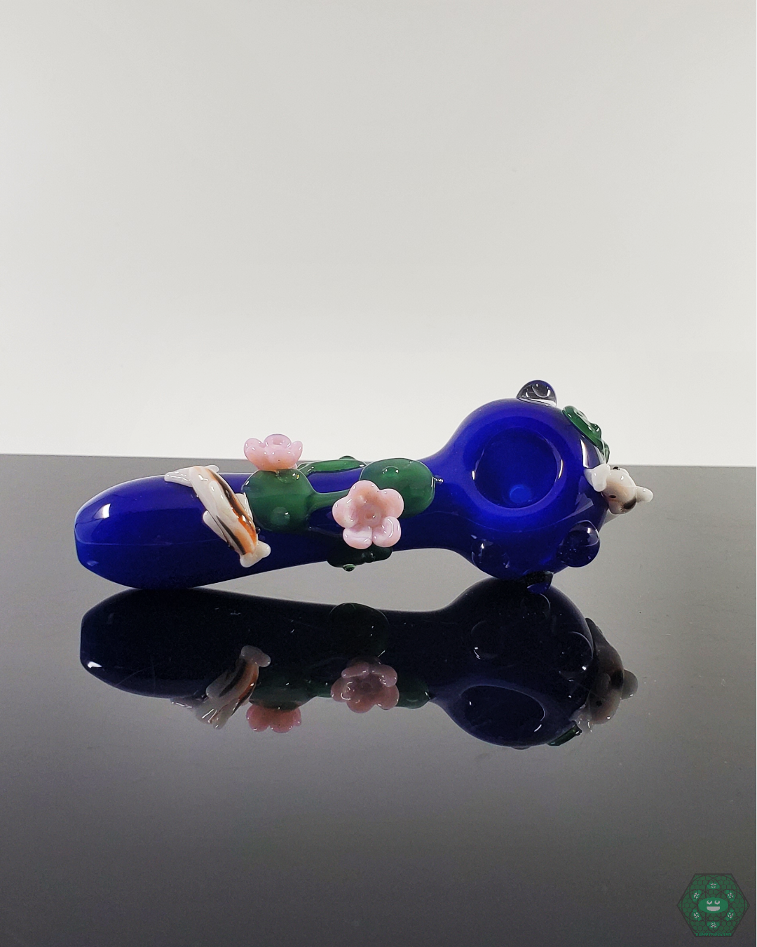 Close-up of the Empire Glassworks Koi Pond Spoon Pipe, highlighting its handcrafted glasswork and smooth airflow design.