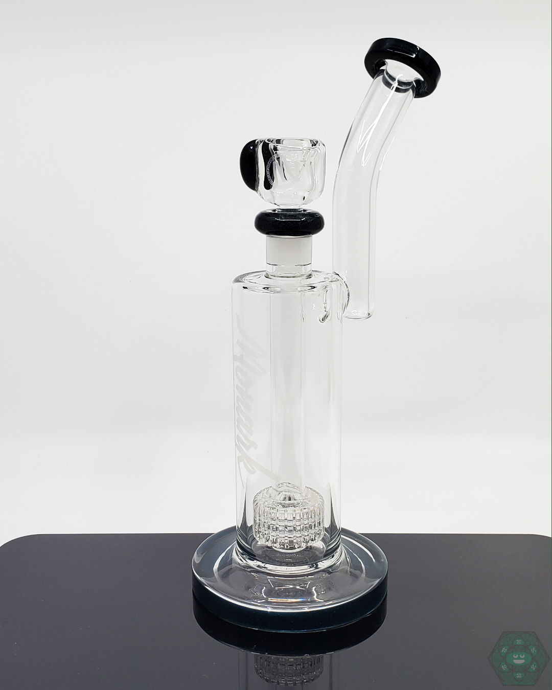 Close-up of the Monark Glass 9.5” Matrix Straight Tube, highlighting its matrix perc for optimal airflow and filtration, ensuring a superior smoking experience.