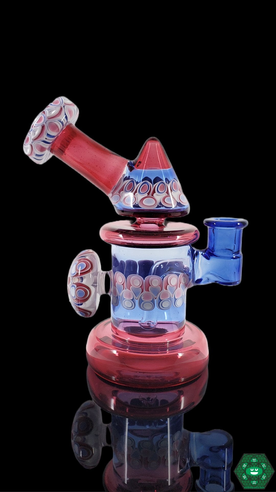 Functional Glass Rig 14mm: The RL Dots Kickback Jammer is a 6.75" rig designed for smooth and precise hits, featuring a 14mm joint, 3-hole perc, and a unique dot stack design.