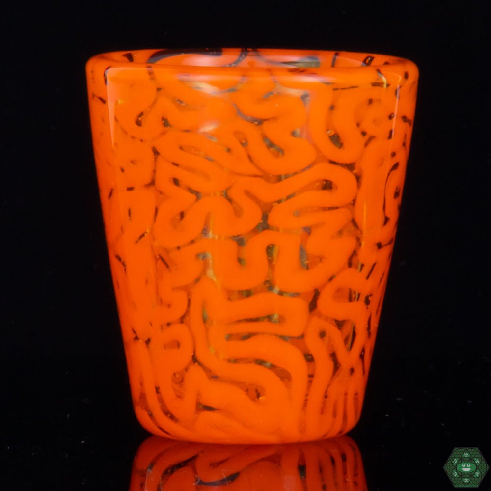Handcrafted Art Glass Shot Glass: This Orange Brain Tech Shot Glass by Algae Glass is a unique and collectible piece of art glass, featuring intricate brain patterns and vibrant colors, perfect for adding a touch of artistic flair to your collection.