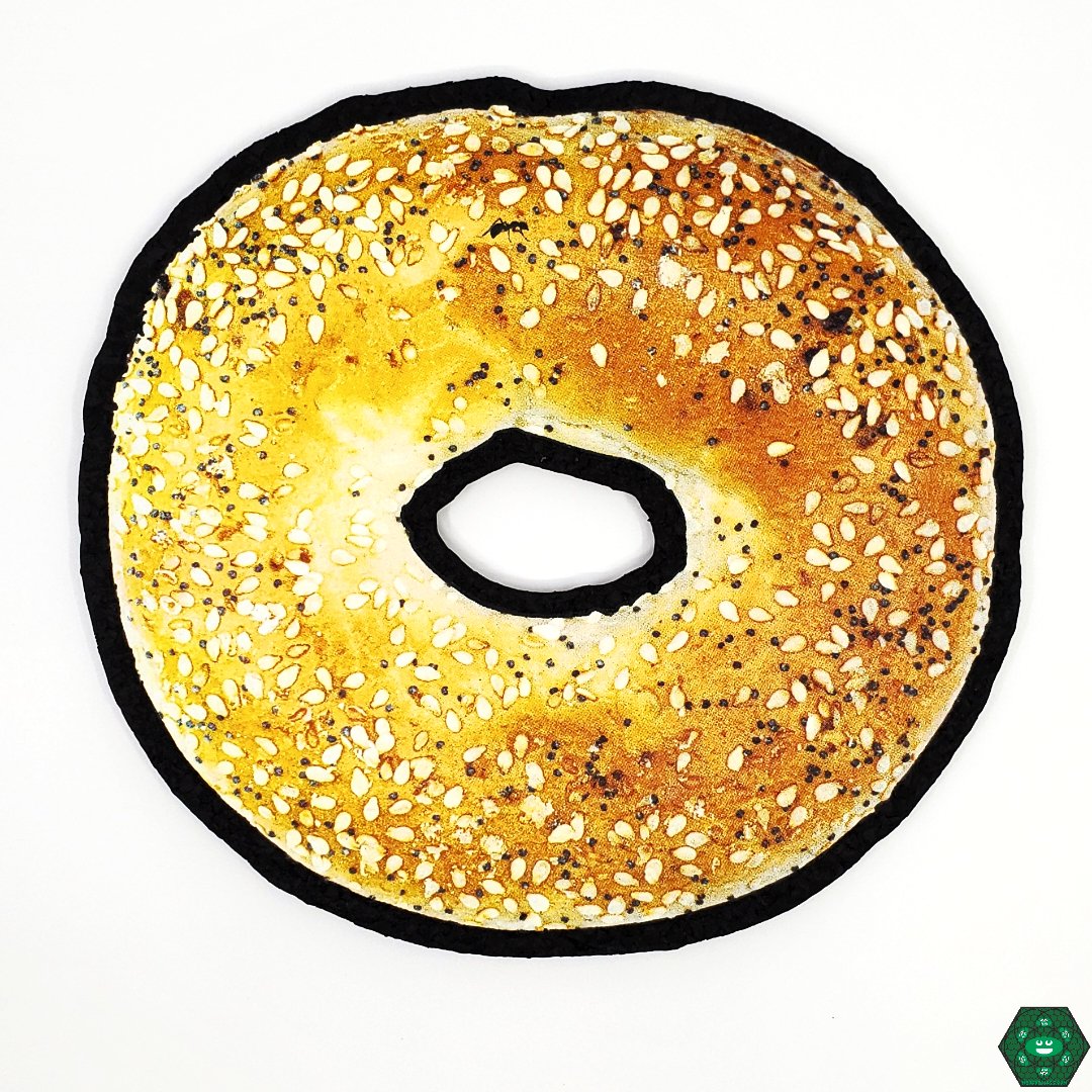 Mood Mats Bagel 8", an eco-friendly piece mat made from upcycled materials, featuring a unique bagel design perfect for protecting glass pieces, durable and heat-resistant for long-lasting use, ideal for glass art enthusiasts and collectors.