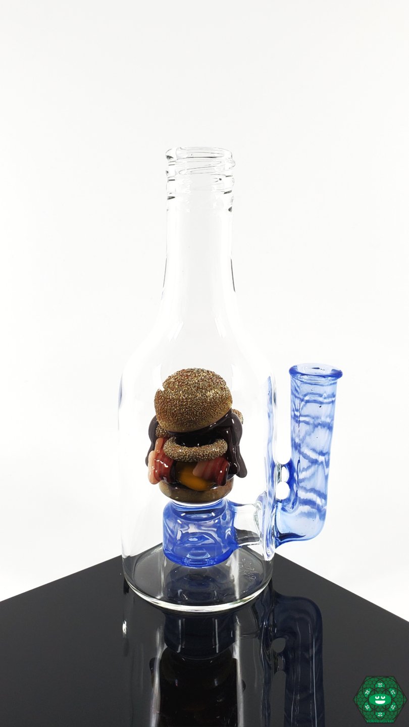 Rosburg Glass 5.75'' Bottle Rig – Blue #2, a compact and collectible concentrate rig with a 10mm joint and branded sticker for authenticity.
