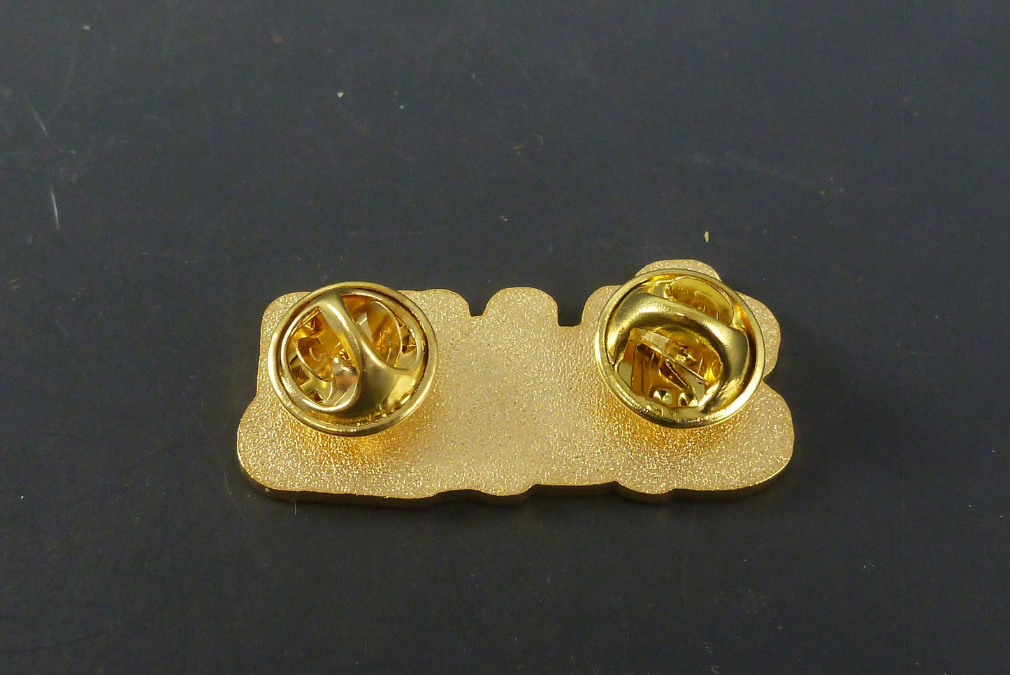 Close-up of Slum Gold Hat Pin, highlighting its high-quality enamel finish and bold design, ideal for adding a unique touch to your collection or accessories.