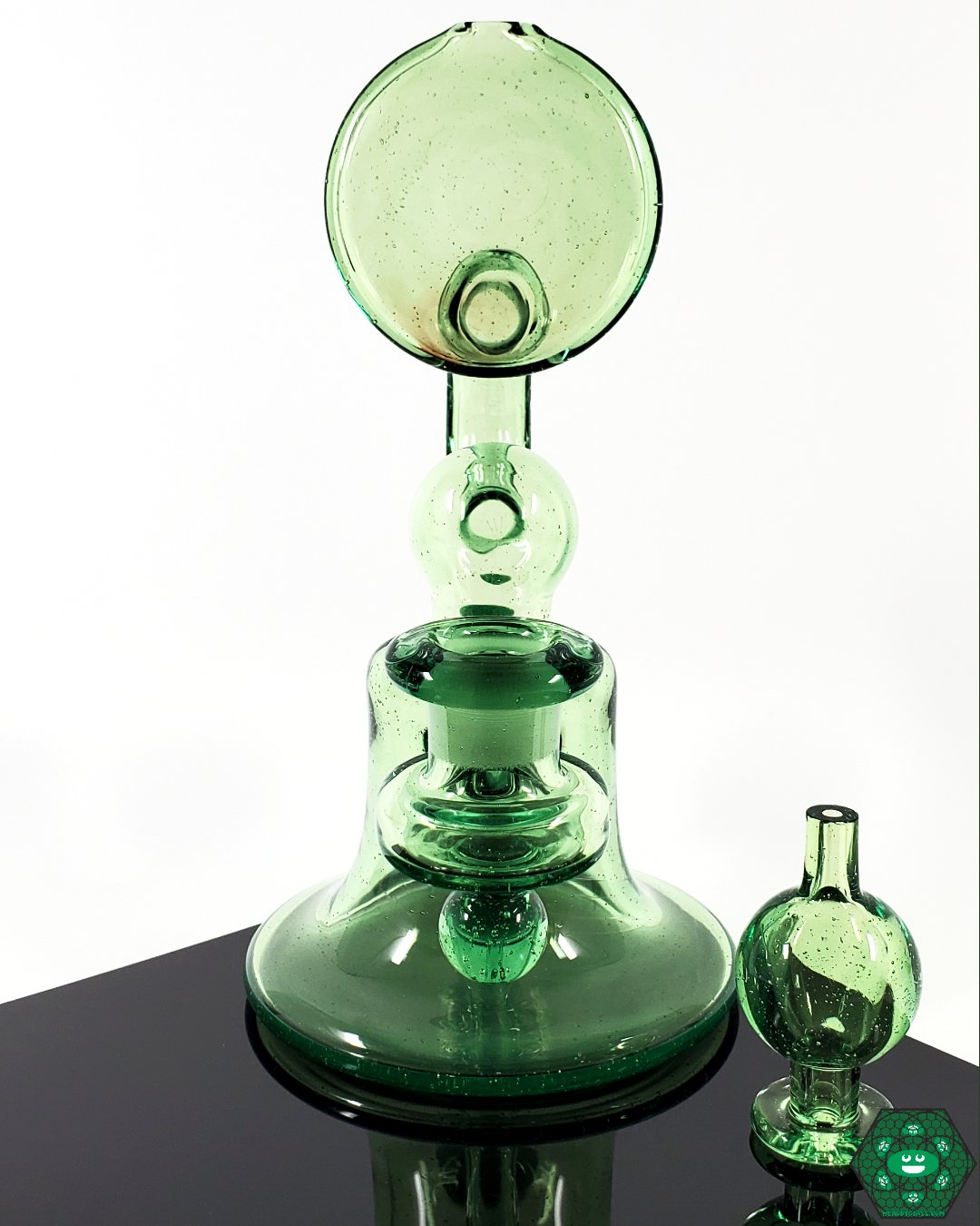 Snafu Glass Voyager Green – 3-hole perc, UV-reactive glass rig with 14mm female joint and bubble cap for smooth and flavorful hits.