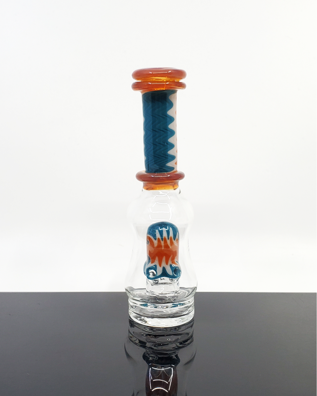 Logi Glass Art Wig Wag Puffco Attachment - Premium Handcrafted Design. Elevate your Puffco device with Logi Glass Art's Wig Wag attachment, featuring a unique 3-hole percolator for smooth draws. Available in Titan, Ghost, and Red Elvis styles, this piece combines artistry and function in each handcrafted detail.