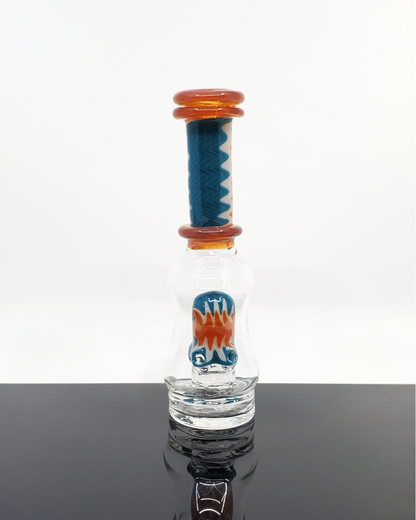 Logi Glass Art Wig Wag Puffco Attachment - Premium Handcrafted Design. Elevate your Puffco device with Logi Glass Art's Wig Wag attachment, featuring a unique 3-hole percolator for smooth draws. Available in Titan, Ghost, and Red Elvis styles, this piece combines artistry and function in each handcrafted detail.
