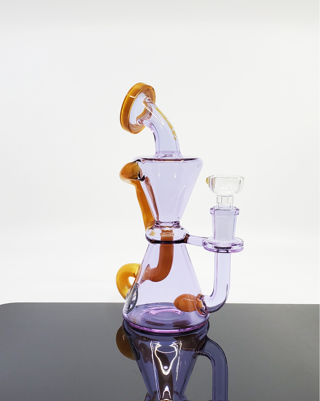 The Elsinore Recycler by MAV Glass is crafted for clean, smooth hits, with a recycler design to enhance airflow and cooling for a refined experience.