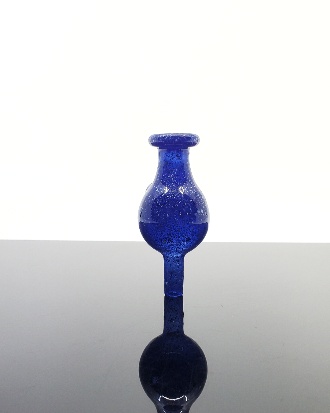 Artistic dichroic glass bubble cap by Jon E. Walker, designed for maximizing flavor retention and precision airflow in dabbing sessions.