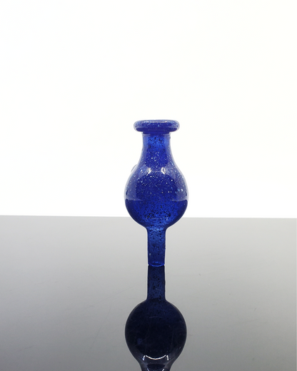 Artistic dichroic glass bubble cap by Jon E. Walker, designed for maximizing flavor retention and precision airflow in dabbing sessions.