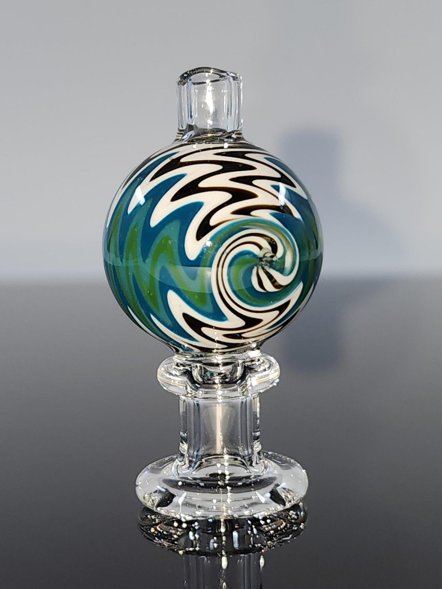  Close-up of the BSG Clear Wig-Wag Reversal Bubble Cap, highlighting its intricate wig-wag design and durable construction for optimal airflow and vapor production.