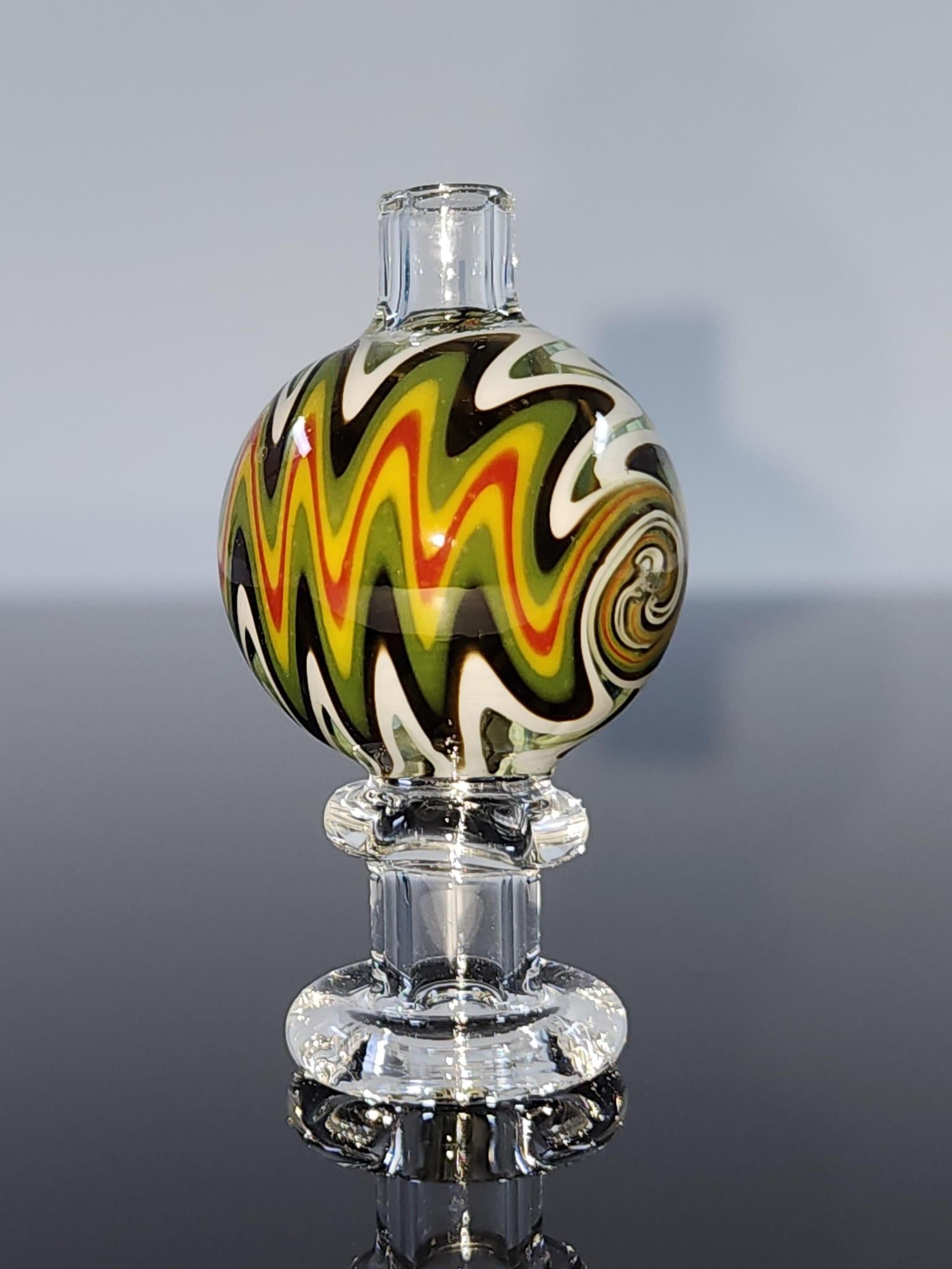 BSG Clear Wig-Wag Reversal Bubble Cap in hand, showing its comfortable grip and precise design, ideal for controlling airflow during dabbing sessions.