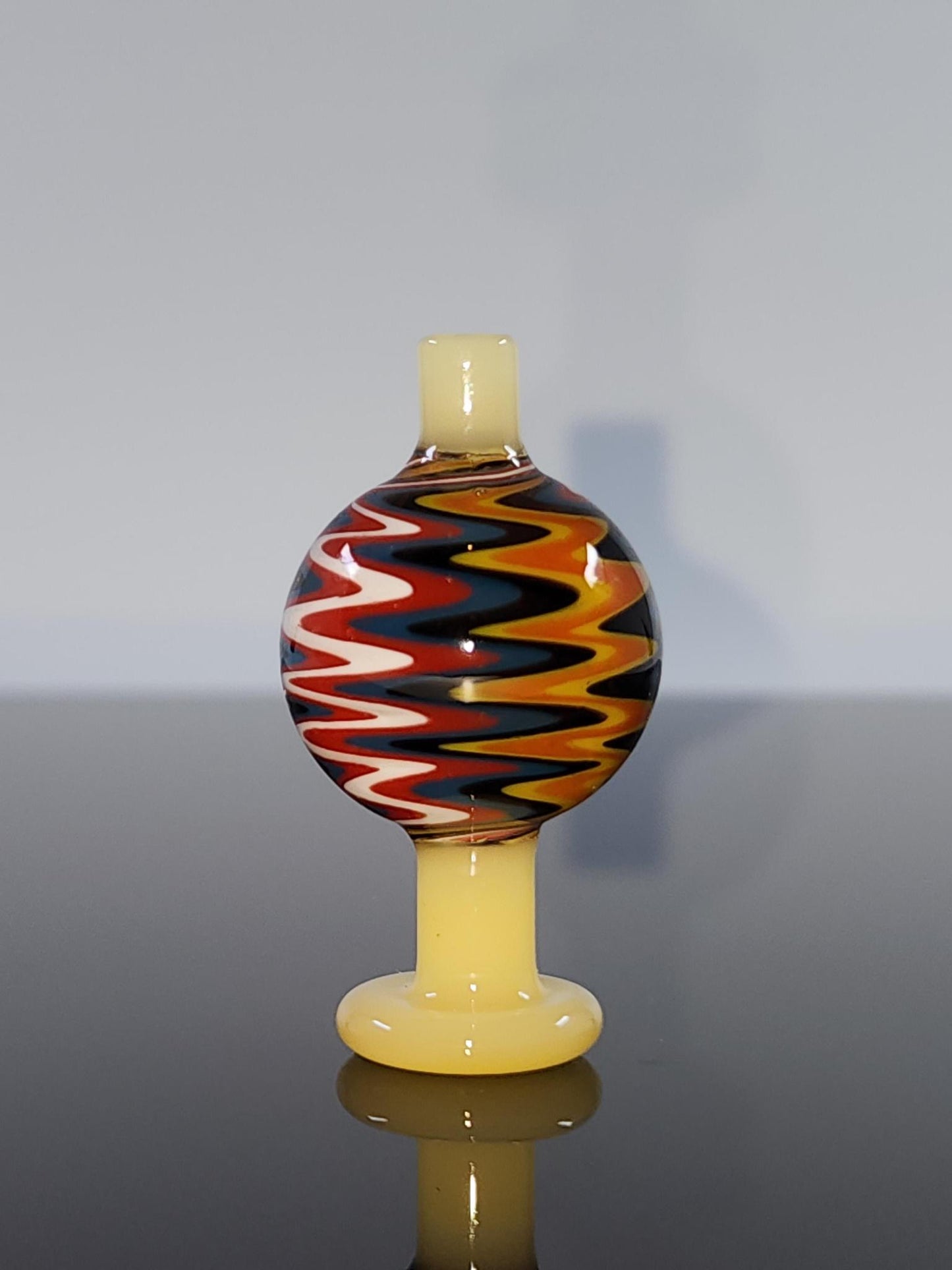 BSG Color Wig-Wag Reversal Bubble Cap in hand, demonstrating its easy-to-handle design and the smooth airflow it provides for enhanced dabbing experiences.