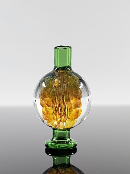 BSG Implosion Bubble Cap in hand, demonstrating its ergonomic design and comfortable grip for controlled airflow and easy use during dabbing sessions.