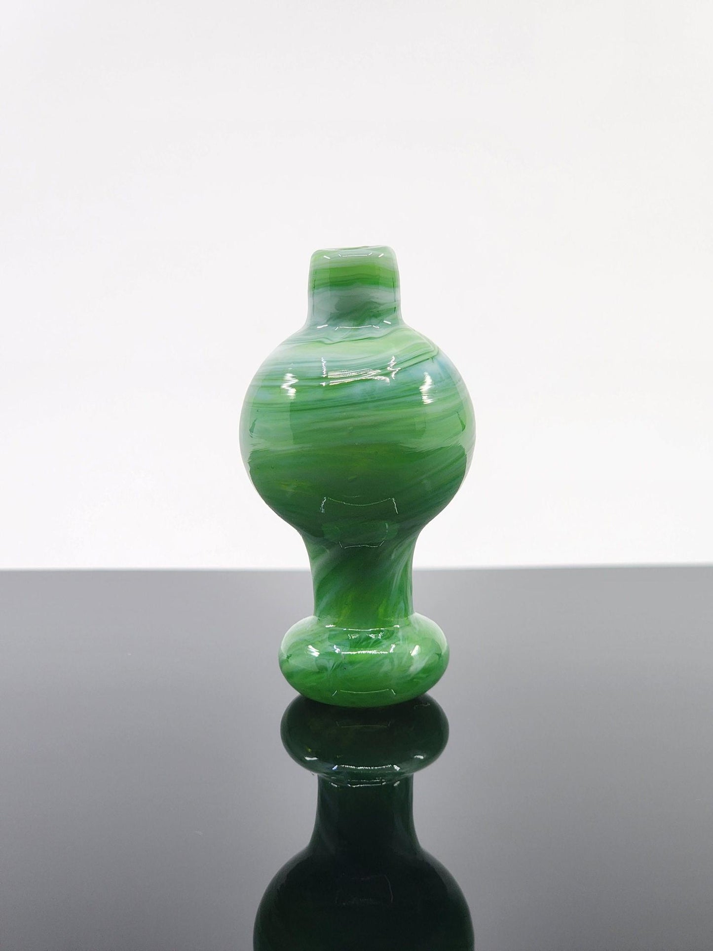  BSG Milky Bubble Cap in hand, demonstrating its comfortable grip and ergonomic design for easy handling during dabbing sessions.