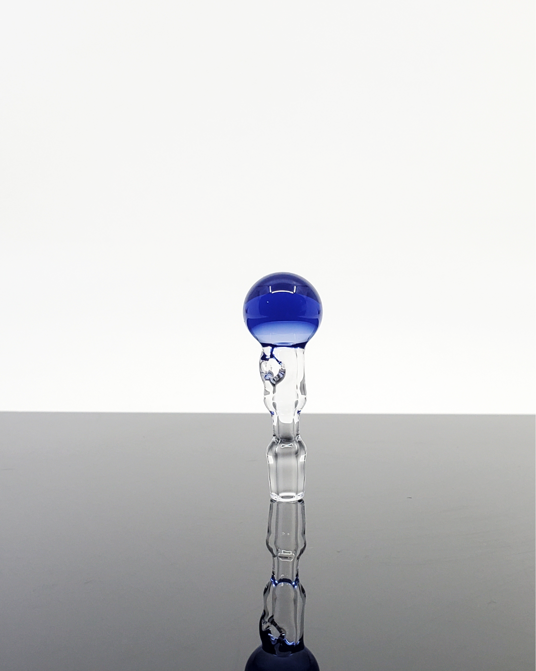 Lifestyle image of the Captain Tokez 3DXL Joystick Cap with color bottom, perfect for Puffco enthusiasts.