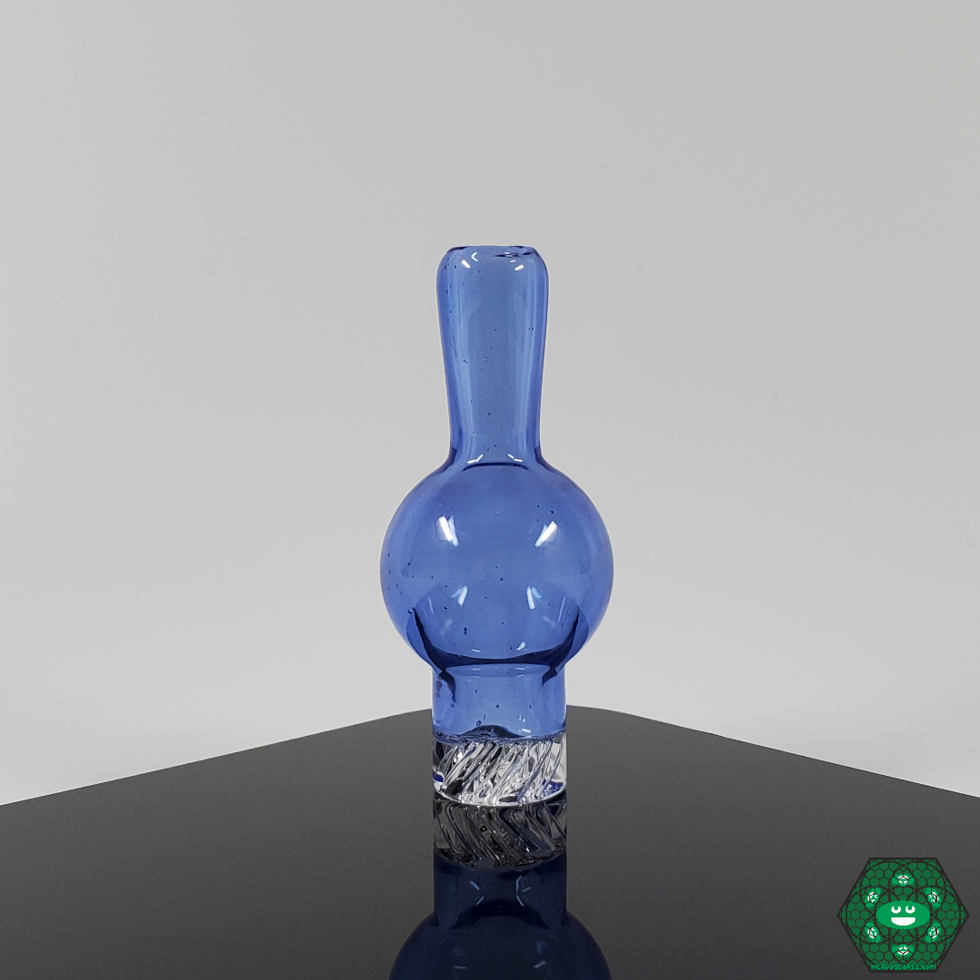 Chill & Relax Glass Spinner Caps in hand, demonstrating their compact, portable design for easy use and efficient vapor control.