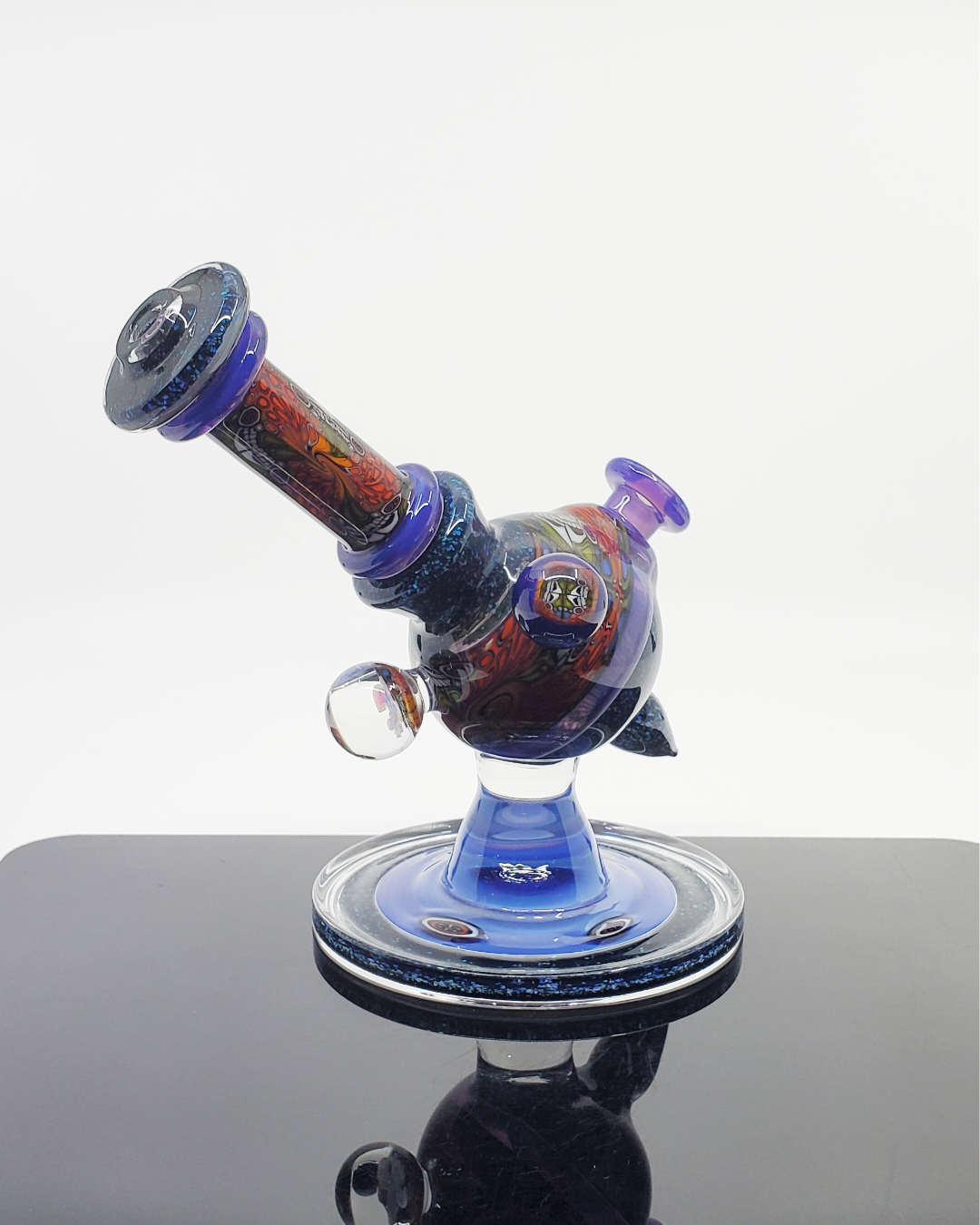  Chip Stack Heliosphere 14mm Rig: The Cajun Glass Chip Stack Heliosphere features intricate chip stack patterns and a clean design in an artisanal 14mm dab rig, perfect for heady glass enthusiasts.
