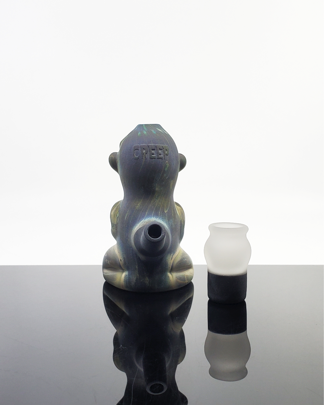 Close-up of the Creep Meditating Minitube, highlighting its detailed artistic design and smooth, durable glasswork.