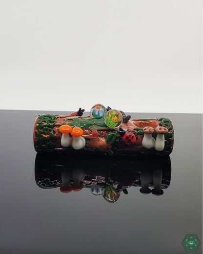 Empire Glassworks Mossy Log Dry Pipe held in hand, highlighting its compact 3.75-inch size and nature-inspired design.