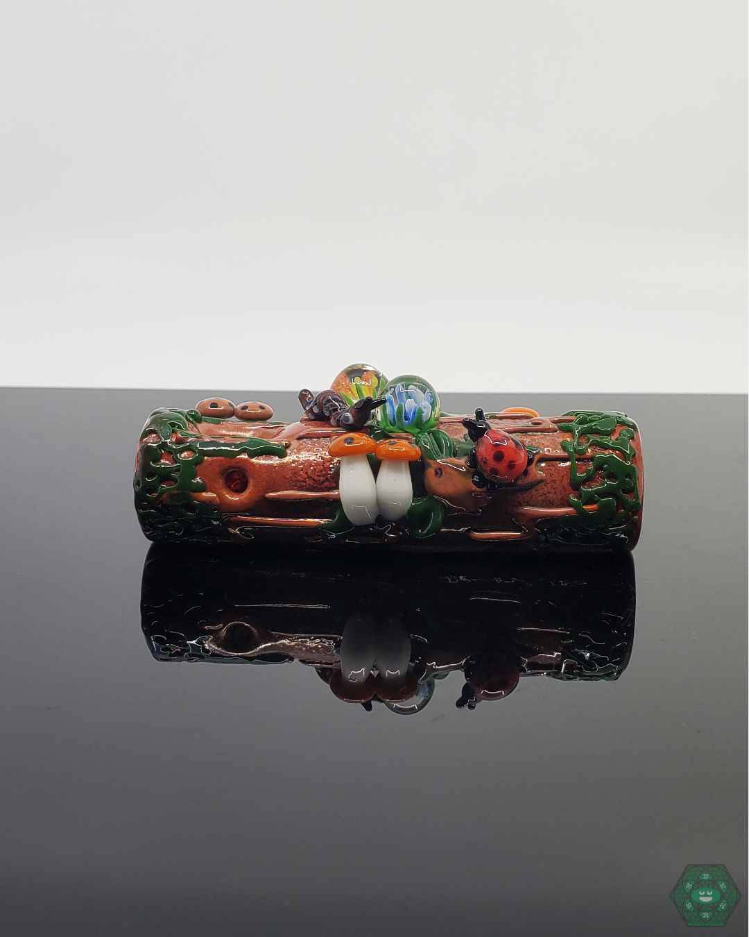  Empire Glassworks Mossy Log Dry Pipe featuring intricate sculpted critters and natural textures for a unique smoking experience.