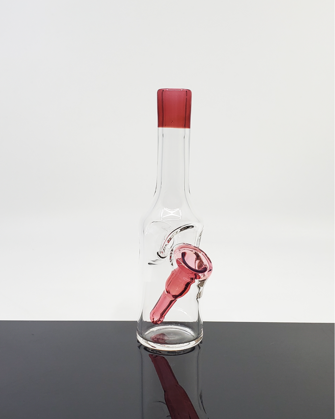 Handcrafted Bro D Glass Mini Bottle Rig with vibrant color accents, perfect for small setups and travel.