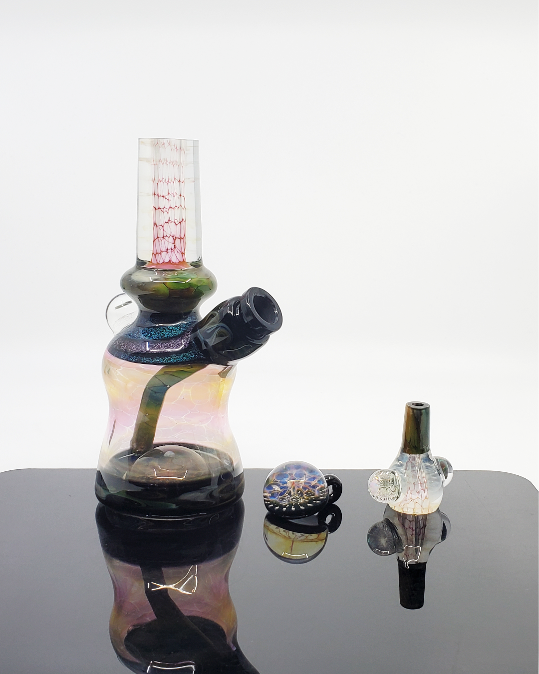 Kenan Tiemeyer Mini Tube featuring fumed glass with intricate dichroic accents, showcasing a unique aesthetic.