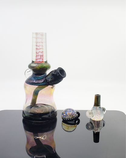 Kenan Tiemeyer Mini Tube featuring fumed glass with intricate dichroic accents, showcasing a unique aesthetic.