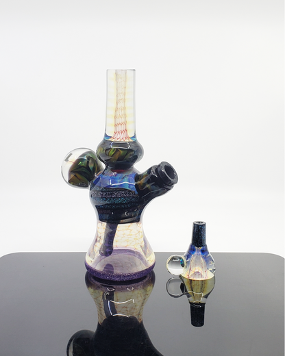 Side view of the Kenan Tiemeyer Minitube, showcasing its compact design and handcrafted glass art.