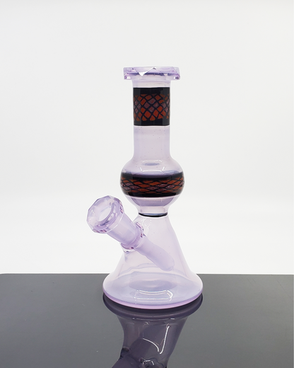 Lilac Faceted Jammer 10mm Rig: The Shipley Glass Lilac Faceted Jammer offers a unique combination of a beautiful lilac color, a faceted design, and a functional 10mm joint, perfect for those who appreciate both artistry and performance in their dab rigs.