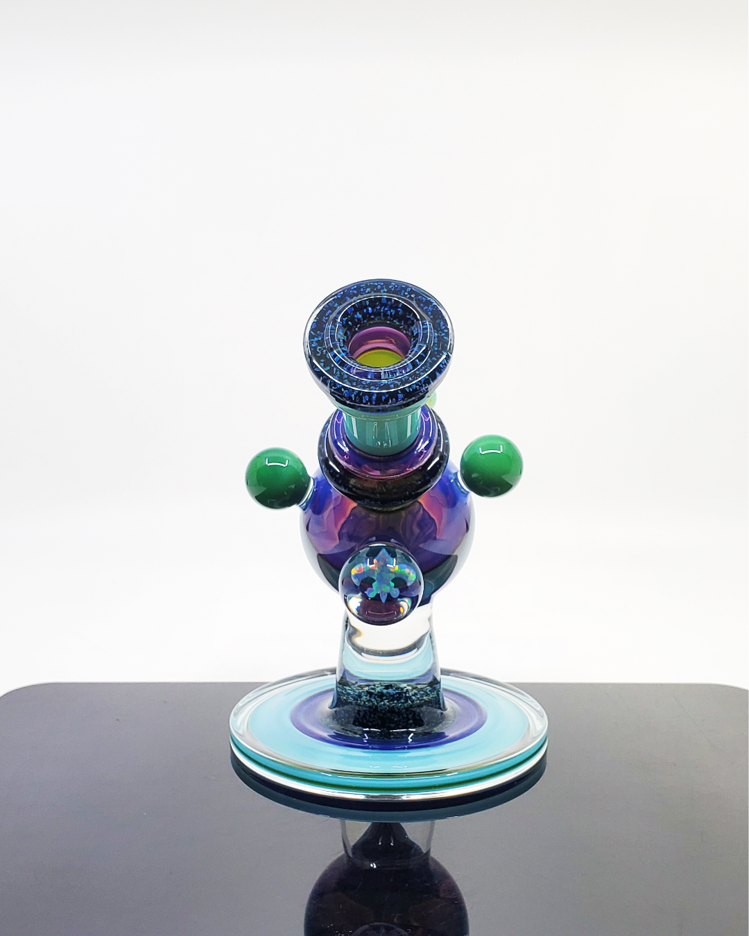 Limited Edition Heady Glass Rig: The Cajun Glass Two-Tone Crushed Opal Heliosphere is a collector's item, featuring eye-catching opal accents, a unique two-tone finish, and a functional 14mm joint.