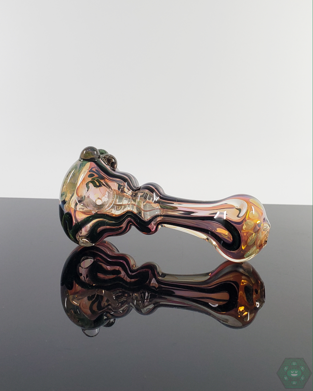 Side view of the LQL Glass Fumed Linework Spoon, showcasing its detailed fumed glass patterns and smooth contours.