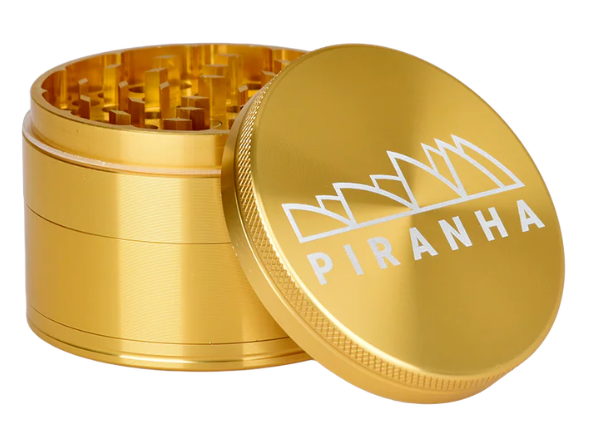 Piranha 2.5" 4-Piece Grinder with herb storage compartment, pollen chamber, and magnetic closure for smooth and efficient grinding.