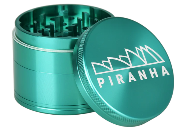 Piranha 2.5" 4-Piece Herb Grinder, with a canvas carry pouch and scraping tool for on-the-go convenience.