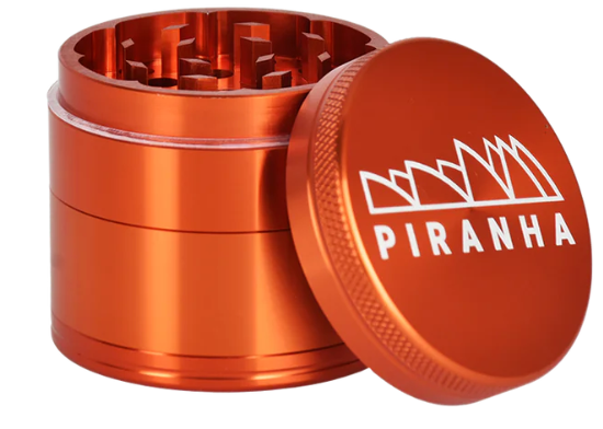  Piranha 2" 4-Piece Anodized Grinder with a canvas carry pouch, magnetic closure, and a smooth grinding mechanism for herbs.