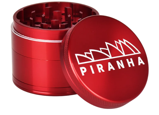 Piranha 4-Piece 2.5" Grinder, featuring razor-sharp geometric teeth, magnetic closure, and a pollen chamber for smooth grinding.