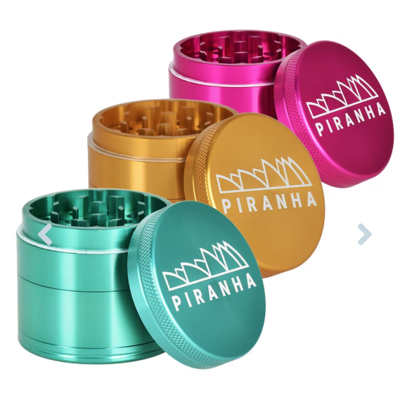 Piranha 4-Piece 2" Grinder made from anodized aluminum with razor-sharp teeth, magnetic closure, pollen chamber, and canvas carry pouch for easy transport.

