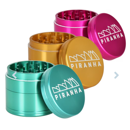 Piranha 4-Piece 2" Grinder made from anodized aluminum with razor-sharp teeth, magnetic closure, pollen chamber, and canvas carry pouch for easy transport.

