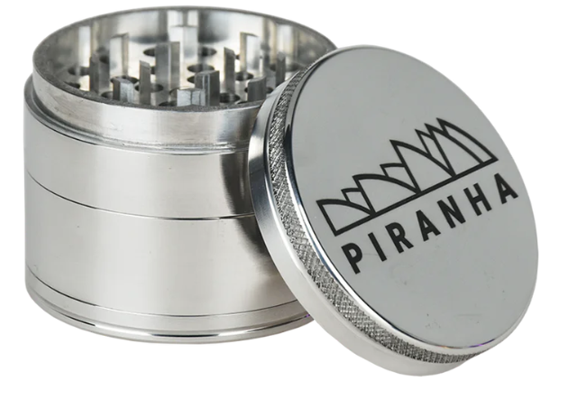 Piranha 4-Piece Grinder Set, 2.2 inches wide, with razor-sharp geometric teeth, magnetic closure, and a pollen chamber.
