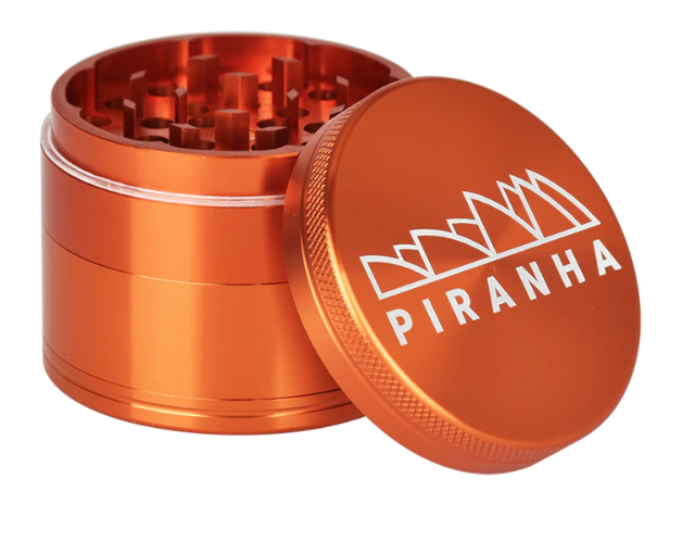 Piranha 4-Piece 2.2" Grinder, designed for smooth grinding with magnetic closure and built-in pollen chamber for herb storage.