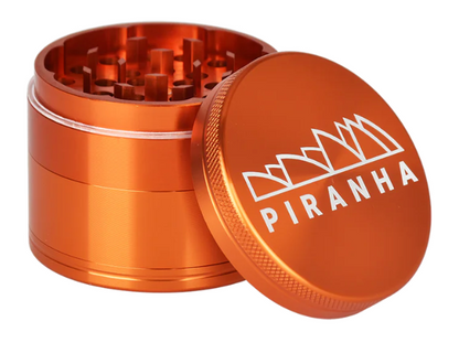 Piranha 4-Piece 2.2" Grinder, designed for smooth grinding with magnetic closure and built-in pollen chamber for herb storage.
