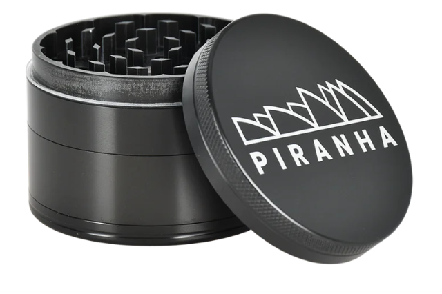 Piranha 4-Piece Grinder, 2.5" in diameter, featuring a pollen chamber, sifting screen, and magnetic closure for easy herb grinding.