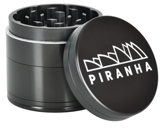  Piranha 4-Piece 2" Grinder made of durable anodized aluminum, featuring a magnetic closure and sifting screen for clean results.