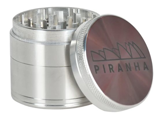 Piranha 4-Piece Grinder with razor-sharp geometric teeth, a canvas carry pouch, and magnetic closure for secure use and transport.
