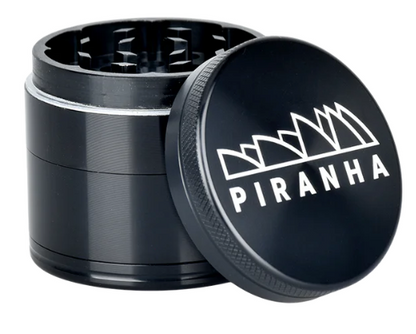 Piranha 4-Piece Grinder with pollen chamber, 2" in diameter, offering a smooth grind and easy herb storage.