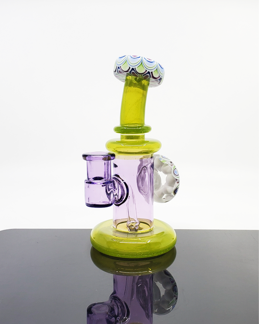 RL Dots Dotstack Jammer with Mouth Cab, a 14mm artistic dab rig featuring an intricate dotstack pattern and a cabbed mouthpiece, combining functionality with a modern aesthetic, suited for art enthusiasts and collectors alike.