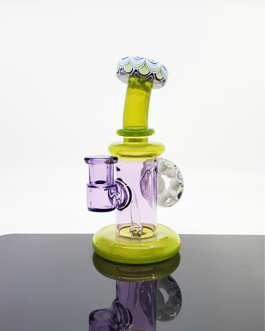 RL Dots Dotstack Jammer with Mouth Cab, a 14mm artistic dab rig featuring an intricate dotstack pattern and a cabbed mouthpiece, combining functionality with a modern aesthetic, suited for art enthusiasts and collectors alike.