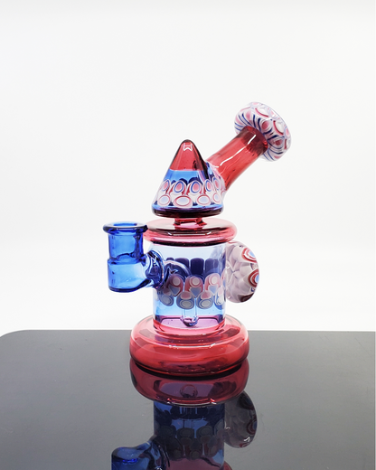 RL Dots Kickback Jammer, a high-quality 14mm dab rig featuring a unique dot stack marble accent, 3-hole perc, and 90-degree joint for smooth, precise hits, a 6.75" rig perfect for glass collectors seeking style and functionality.