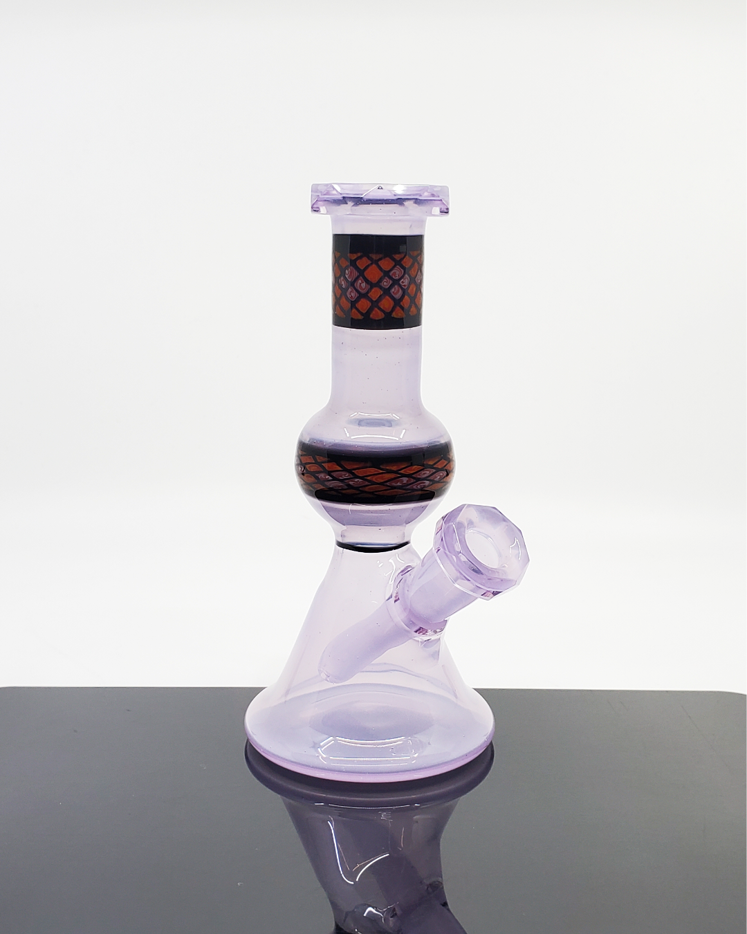 Shipley Glass Lilac Faceted Jammer, a beautiful 10mm dab rig in a lilac hue with a faceted design, blending function and artistry, ideal for those who value both aesthetic and performance in their glassware.